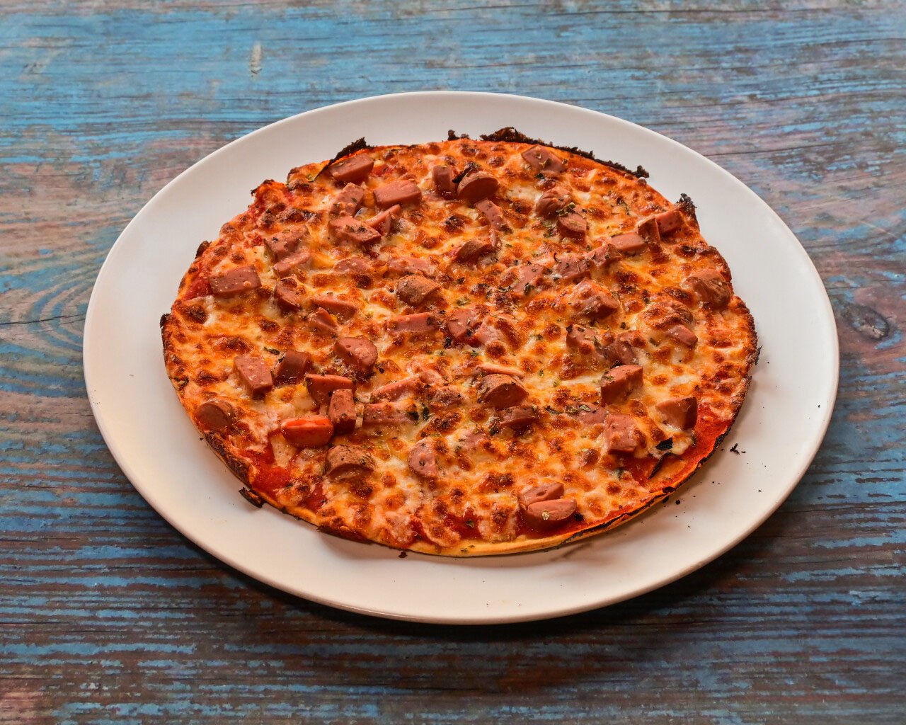 Nuestra Carta 5 pizza de Tomate, Salchichas, Mozzarella y Orégano.