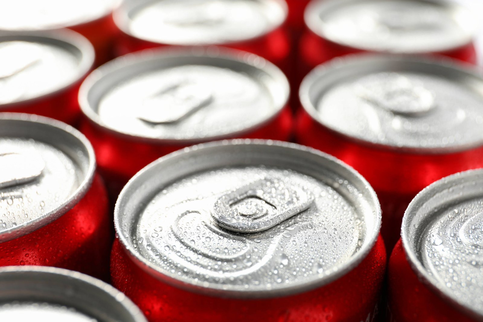 Nuestra Carta 55 cans with soda all over background close up 2023 11 27 05 25 07 utc scaled